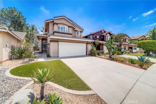 11015 Charleston St, Rancho Cucamonga, CA 91701 - view of front of house featuring an attached garage, stucco siding, driveway, a gate, and a residential view