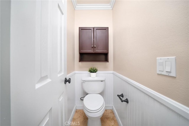 11015 Charleston St, Rancho Cucamonga, CA 91701 - bathroom featuring wainscoting, toilet, ornamental molding, and a decorative wall