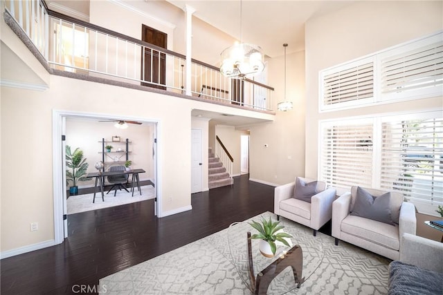 11015 Charleston St, Rancho Cucamonga, CA 91701 - living area featuring stairway, wood finished floors, baseboards, a towering ceiling, and a chandelier