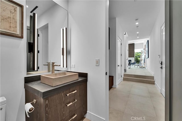 25057 Lewis And Clark Rd, Hidden Hills, CA 91302 - bathroom featuring vanity, toilet, tile patterned flooring, baseboards, and recessed lighting