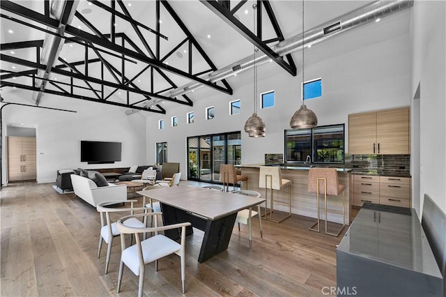 25057 Lewis And Clark Rd, Hidden Hills, CA 91302 - dining area featuring high vaulted ceiling, light wood finished floors, and beamed ceiling