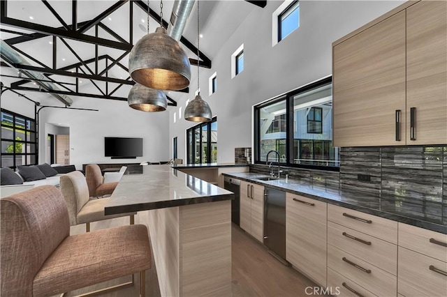 25057 Lewis And Clark Rd, Hidden Hills, CA 91302 - kitchen featuring modern cabinets, a sink, a high ceiling, light brown cabinets, and open floor plan