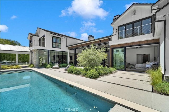 25057 Lewis And Clark Rd, Hidden Hills, CA 91302 - back of house featuring a balcony, a chimney, an outdoor pool, and a patio