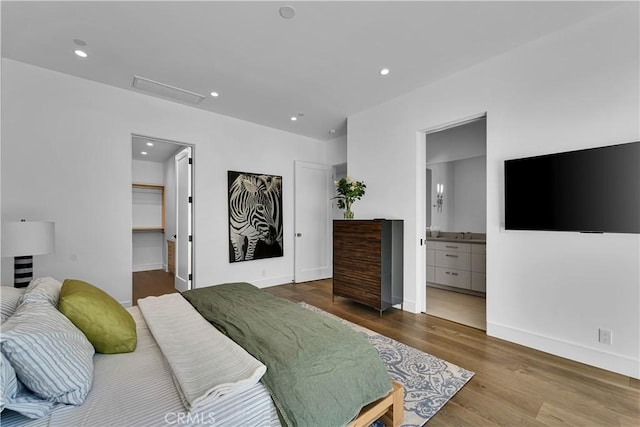 25057 Lewis And Clark Rd, Hidden Hills, CA 91302 - bedroom with wood finished floors, recessed lighting, baseboards, attic access, and ensuite bathroom