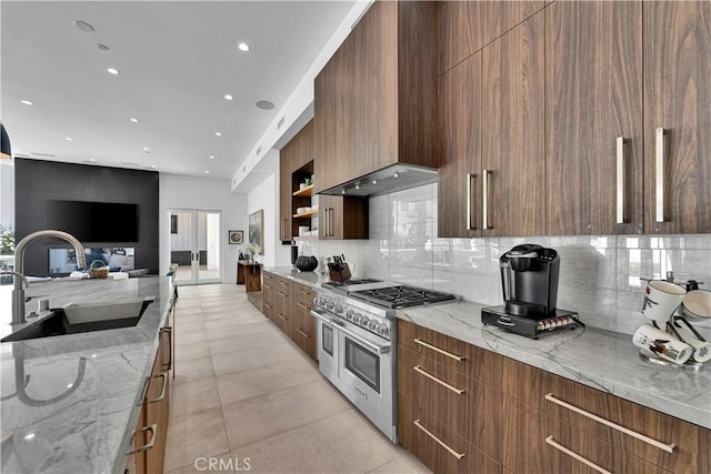 25057 Lewis And Clark Rd, Hidden Hills, CA 91302 - kitchen with range with two ovens, a sink, modern cabinets, backsplash, and recessed lighting