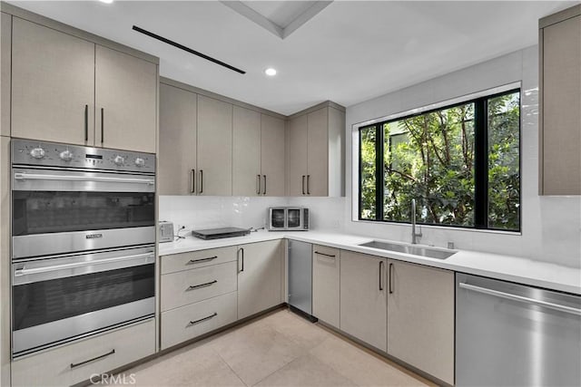25057 Lewis And Clark Rd, Hidden Hills, CA 91302 - kitchen with stainless steel appliances, a sink, gray cabinetry, plenty of natural light, and recessed lighting