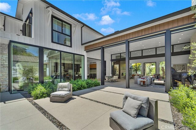 25057 Lewis And Clark Rd, Hidden Hills, CA 91302 - back of property with a patio area and board and batten siding