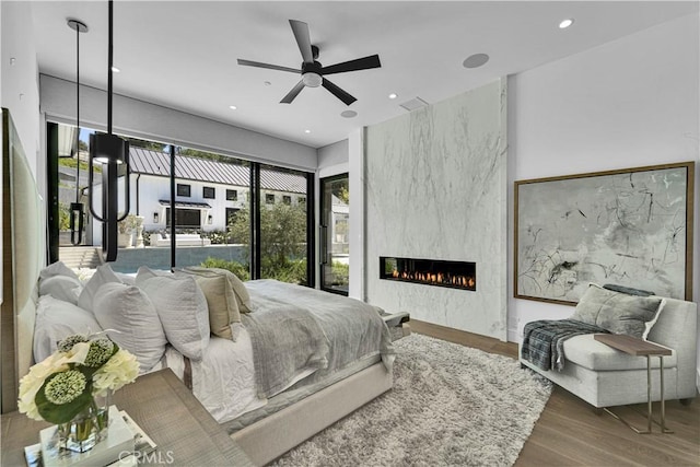 25057 Lewis And Clark Rd, Hidden Hills, CA 91302 - bedroom featuring wood finished floors, a large fireplace, and recessed lighting