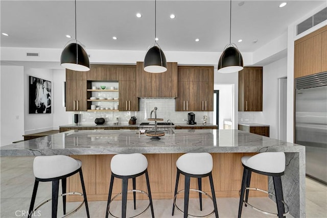 25057 Lewis And Clark Rd, Hidden Hills, CA 91302 - kitchen featuring built in fridge, modern cabinets, open shelves, decorative backsplash, and a spacious island