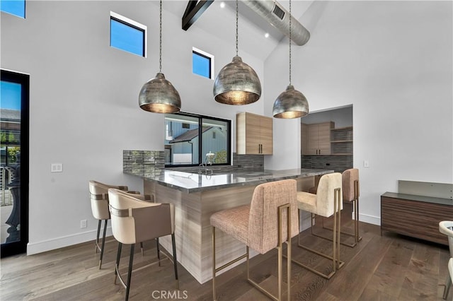 25057 Lewis And Clark Rd, Hidden Hills, CA 91302 - kitchen featuring high vaulted ceiling, beamed ceiling, wood finished floors, baseboards, and a breakfast bar