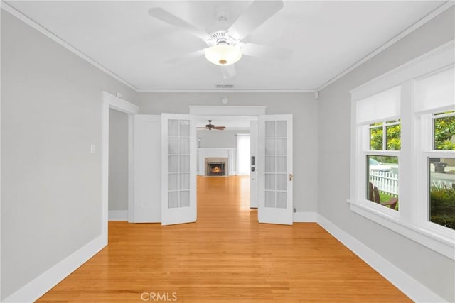 310 Hermosa, Long Beach, CA 90802 - empty room featuring a ceiling fan, light wood-style flooring, baseboards, a fireplace with flush hearth, and crown molding