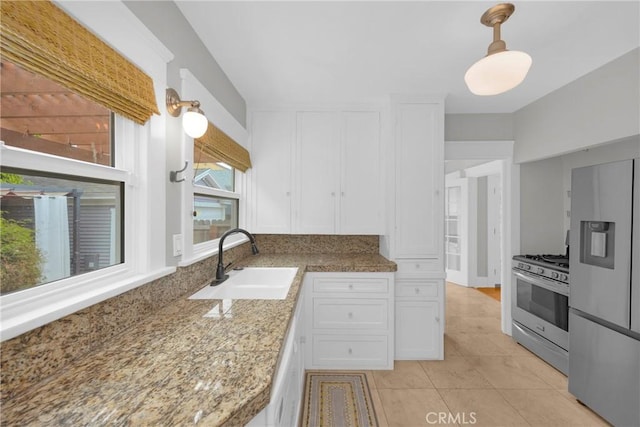 310 Hermosa, Long Beach, CA 90802 - kitchen featuring refrigerator with ice dispenser, gas range, white cabinets, light tile patterned floors, and decorative light fixtures