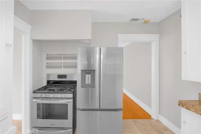 310 Hermosa, Long Beach, CA 90802 - kitchen featuring stainless steel appliances, light tile patterned flooring, and light stone counters