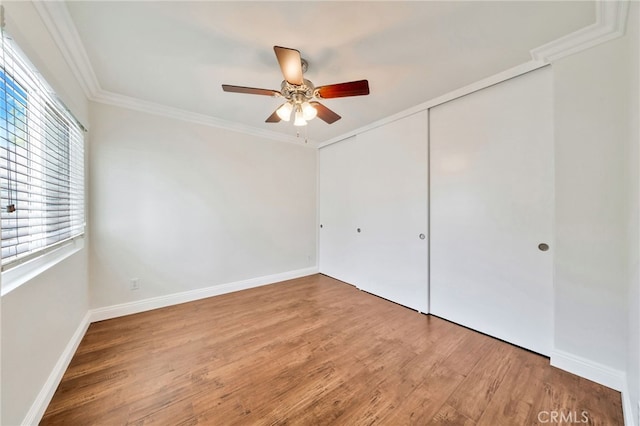 6211 Newhaven Ct Unit 128, Yorba Linda, CA 92887 - unfurnished bedroom with multiple windows, a closet, crown molding, wood finished floors, and baseboards