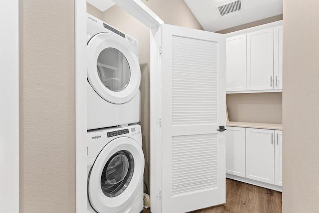 2896 Via Alta Pl, San Diego, CA 92108 - laundry room with stacked washer / dryer and wood finished floors