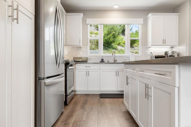 2896 Via Alta Pl, San Diego, CA 92108 - kitchen with freestanding refrigerator, a sink, backsplash, and white cabinets