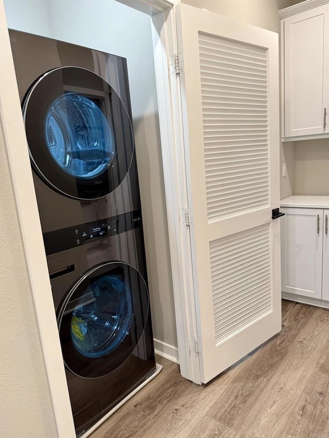 2896 Via Alta Pl, San Diego, CA 92108 - laundry area with stacked washer and clothes dryer and light wood-style floors