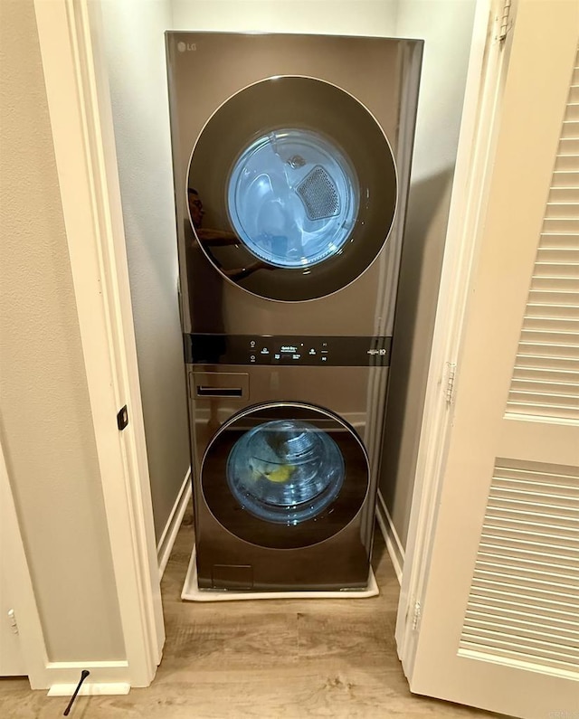 2896 Via Alta Pl, San Diego, CA 92108 - washroom with stacked washer / drying machine and wood finished floors