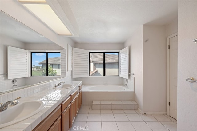 2207 Inverness Ct, Oxnard, CA 93036 - full bath with plenty of natural light, a garden tub, tile patterned floors, and double vanity