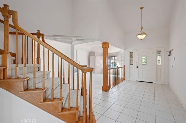 2207 Inverness Ct, Oxnard, CA 93036 - entryway featuring ornate columns, high vaulted ceiling, light tile patterned floors, and stairs