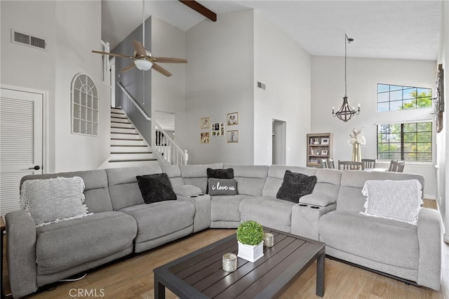7209 Copper Creek Way, Bakersfield, CA 93308 - living area featuring high vaulted ceiling, a chandelier, wood finished floors, stairs, and a ceiling fan