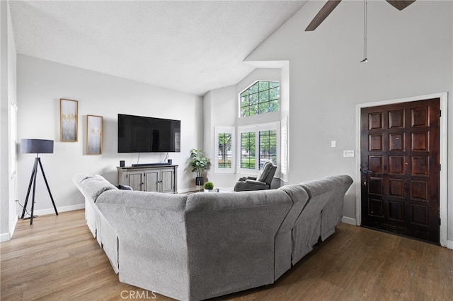 7209 Copper Creek Way, Bakersfield, CA 93308 - living room featuring high vaulted ceiling, wood finished floors, a ceiling fan, and baseboards