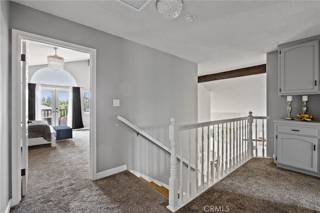 7209 Copper Creek Way, Bakersfield, CA 93308 - hallway with dark colored carpet, an upstairs landing, french doors, and a textured ceiling