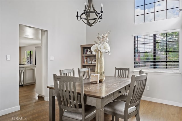 7209 Copper Creek Way, Bakersfield, CA 93308 - dining space featuring a chandelier, baseboards, wood finished floors, and a high ceiling