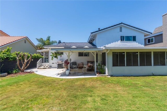 17392 Almelo Ln, Huntington Beach, CA 92649 - rear view of house featuring a patio, stucco siding, and a lawn