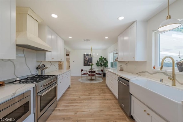 17392 Almelo Ln, Huntington Beach, CA 92649 - kitchen featuring a sink, custom range hood, appliances with stainless steel finishes, plenty of natural light, and recessed lighting