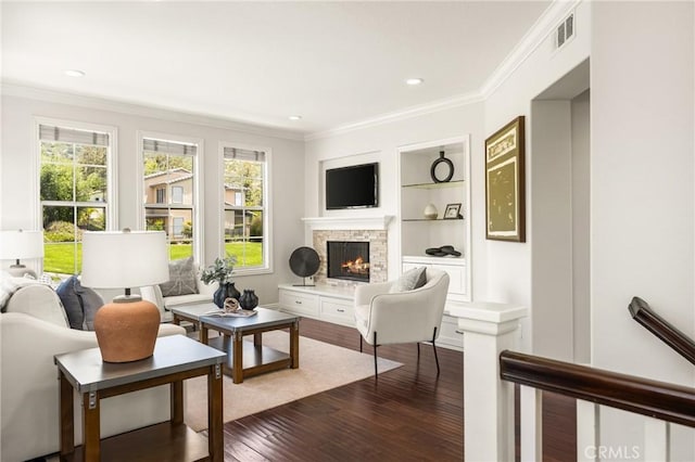 10108 Marchant Ave, Tustin, CA 92782 - living area with healthy amount of natural light, dark wood-style flooring, ornamental molding, a stone fireplace, and built in features
