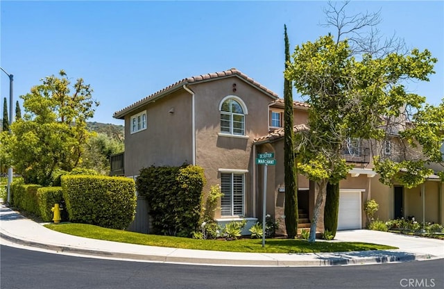10108 Marchant Ave, Tustin, CA 92782 - mediterranean / spanish home featuring driveway, stucco siding, a garage, and a tile roof