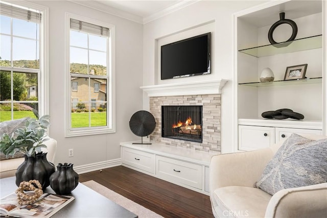 10108 Marchant Ave, Tustin, CA 92782 - living room featuring dark wood-style floors, ornamental molding, a warm lit fireplace, baseboards, and built in features