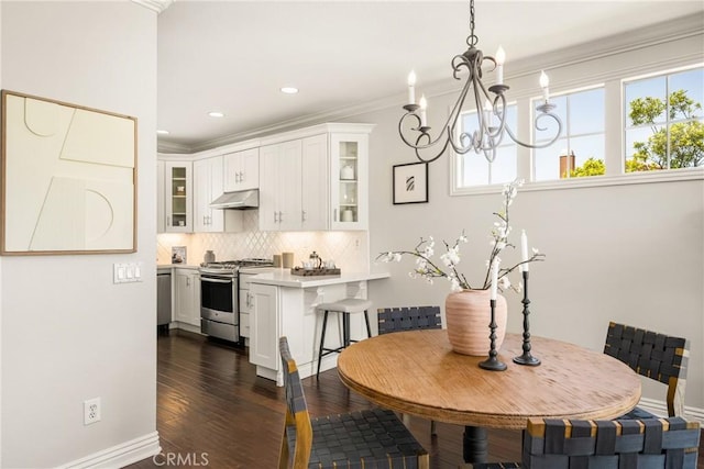 10108 Marchant Ave, Tustin, CA 92782 - dining space featuring plenty of natural light, ornamental molding, a chandelier, dark wood-style floors, and recessed lighting