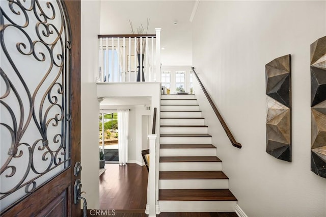 10108 Marchant Ave, Tustin, CA 92782 - stairs with a towering ceiling, wood finished floors, and baseboards