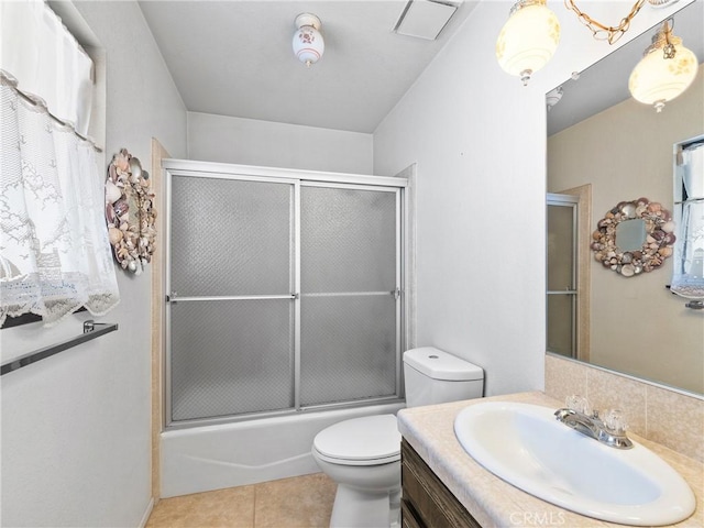 20654 Ottawa Rd, Apple Valley, CA 92308 - full bathroom with toilet, vanity, bath / shower combo with glass door, tile patterned flooring, and tasteful backsplash