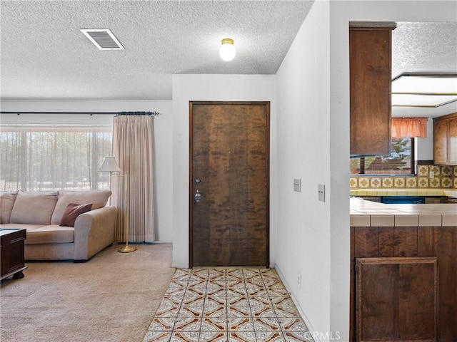 20654 Ottawa Rd, Apple Valley, CA 92308 - entrance foyer with plenty of natural light, a textured ceiling, and light carpet