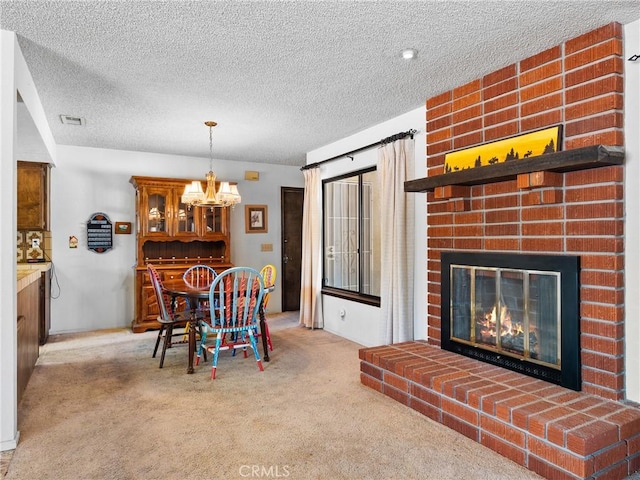 20654 Ottawa Rd, Apple Valley, CA 92308 - dining area featuring carpet, a textured ceiling, a fireplace, and a chandelier