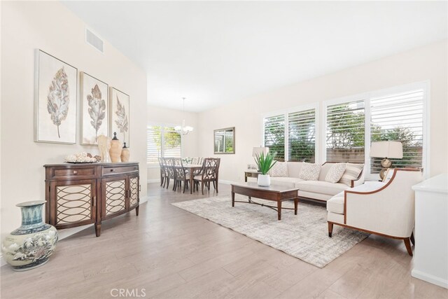 18559 Stonegate Ln, Rowland Heights, CA 91748 - living room with a chandelier, light wood-style floors, and baseboards