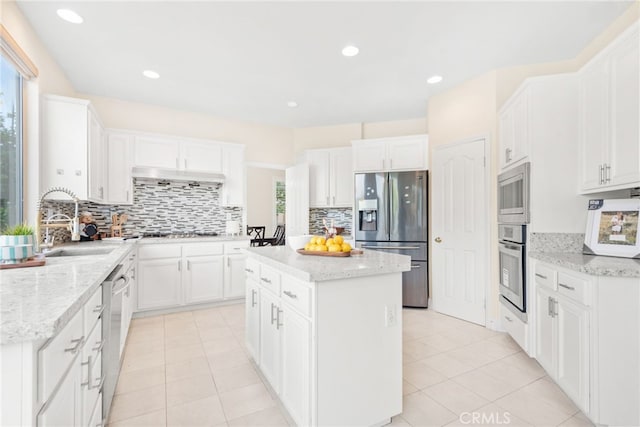 18559 Stonegate Ln, Rowland Heights, CA 91748 - kitchen with appliances with stainless steel finishes, decorative backsplash, a center island, a sink, and recessed lighting