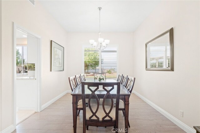 18559 Stonegate Ln, Rowland Heights, CA 91748 - dining room with a chandelier, light wood-type flooring, and baseboards