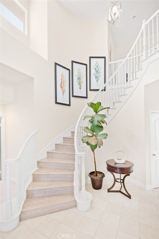 18559 Stonegate Ln, Rowland Heights, CA 91748 - stairs featuring a high ceiling, tile patterned flooring, and baseboards