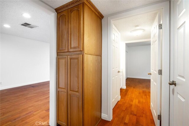 10149 Commerce Ave Unit 8, Tujunga, CA 91042 - hall featuring light wood-style floors, baseboards, a textured ceiling, and recessed lighting