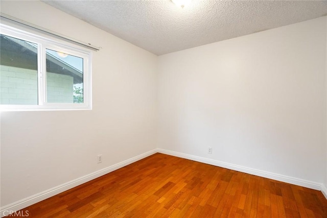 10149 Commerce Ave Unit 8, Tujunga, CA 91042 - unfurnished room with wood finished floors, baseboards, and a textured ceiling