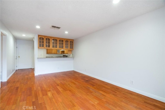 10149 Commerce Ave Unit 8, Tujunga, CA 91042 - unfurnished living room with light wood finished floors, recessed lighting, and baseboards