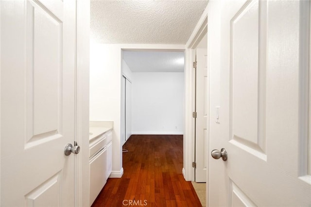10149 Commerce Ave Unit 8, Tujunga, CA 91042 - corridor featuring dark wood finished floors, a textured ceiling, and baseboards