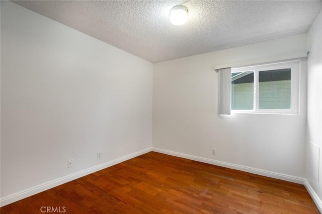 10149 Commerce Ave Unit 8, Tujunga, CA 91042 - spare room featuring wood finished floors, baseboards, and a textured ceiling