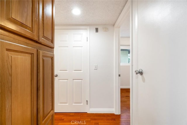 10149 Commerce Ave Unit 8, Tujunga, CA 91042 - hallway featuring a textured ceiling, wood finished floors, baseboards, and recessed lighting