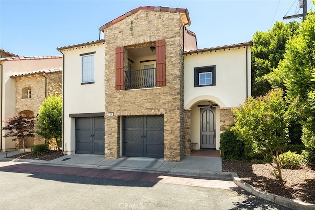 35 Veneto Cir, Chico, CA 95926 - mediterranean / spanish-style house featuring stone siding, stucco siding, a balcony, a garage, and a tiled roof
