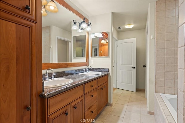 35 Veneto Cir, Chico, CA 95926 - full bath with tile patterned flooring, a relaxing tiled tub, double vanity, baseboards, and a chandelier